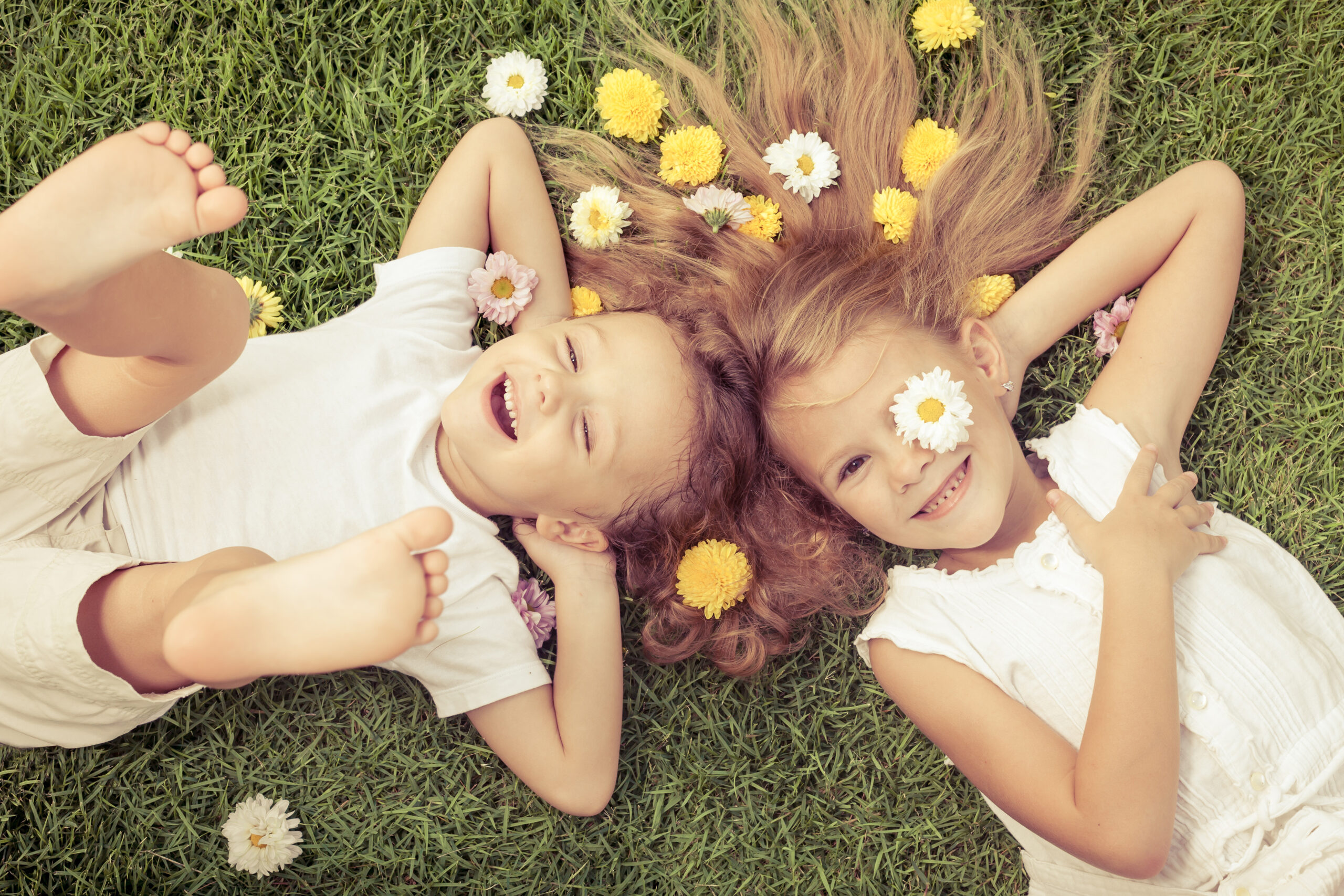 Happy,Little,Boy,And,Girl,Lying,On,The,Grass,At