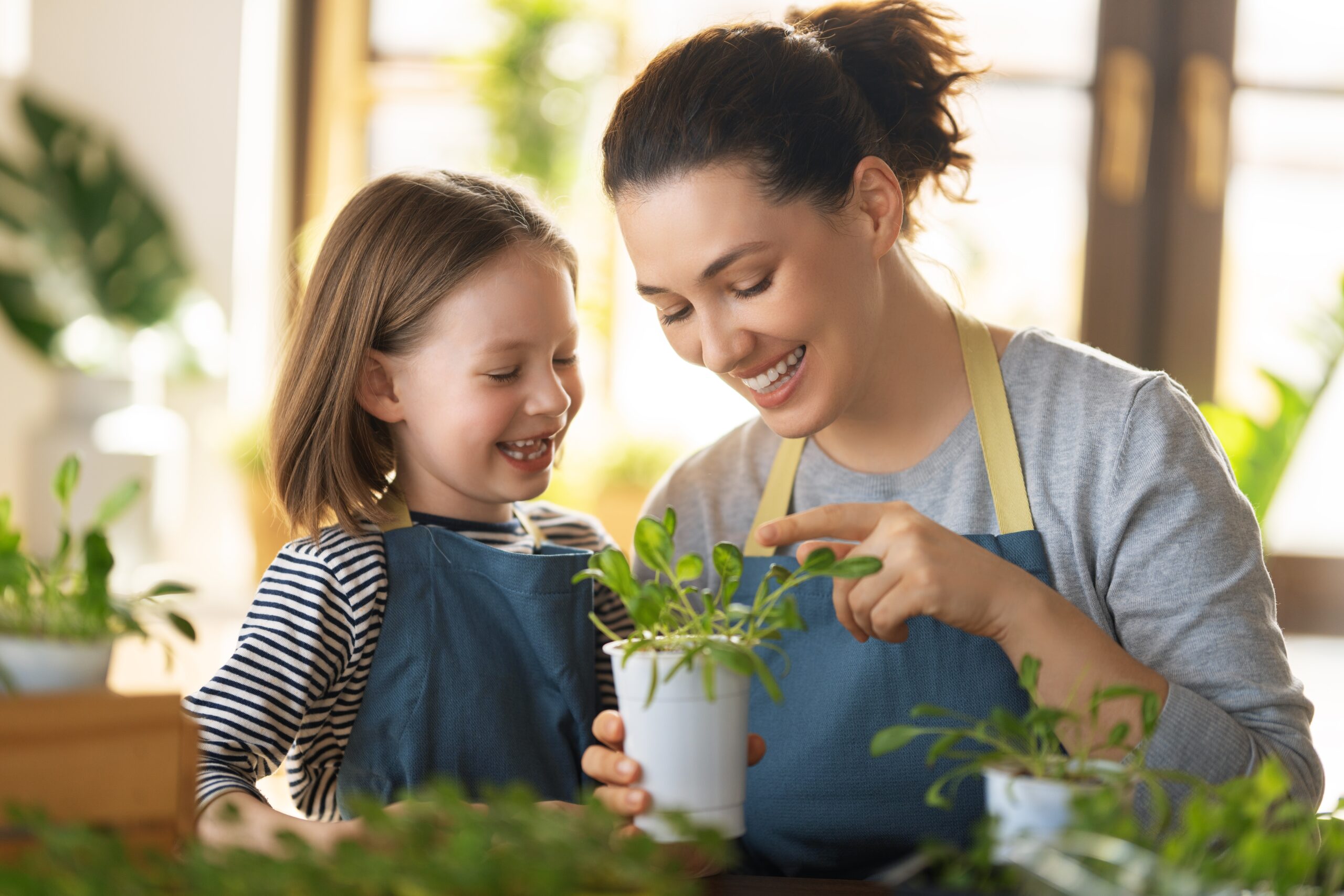 Cute,Child,Girl,Helping,Her,Mother,To,Care,For,Plants.