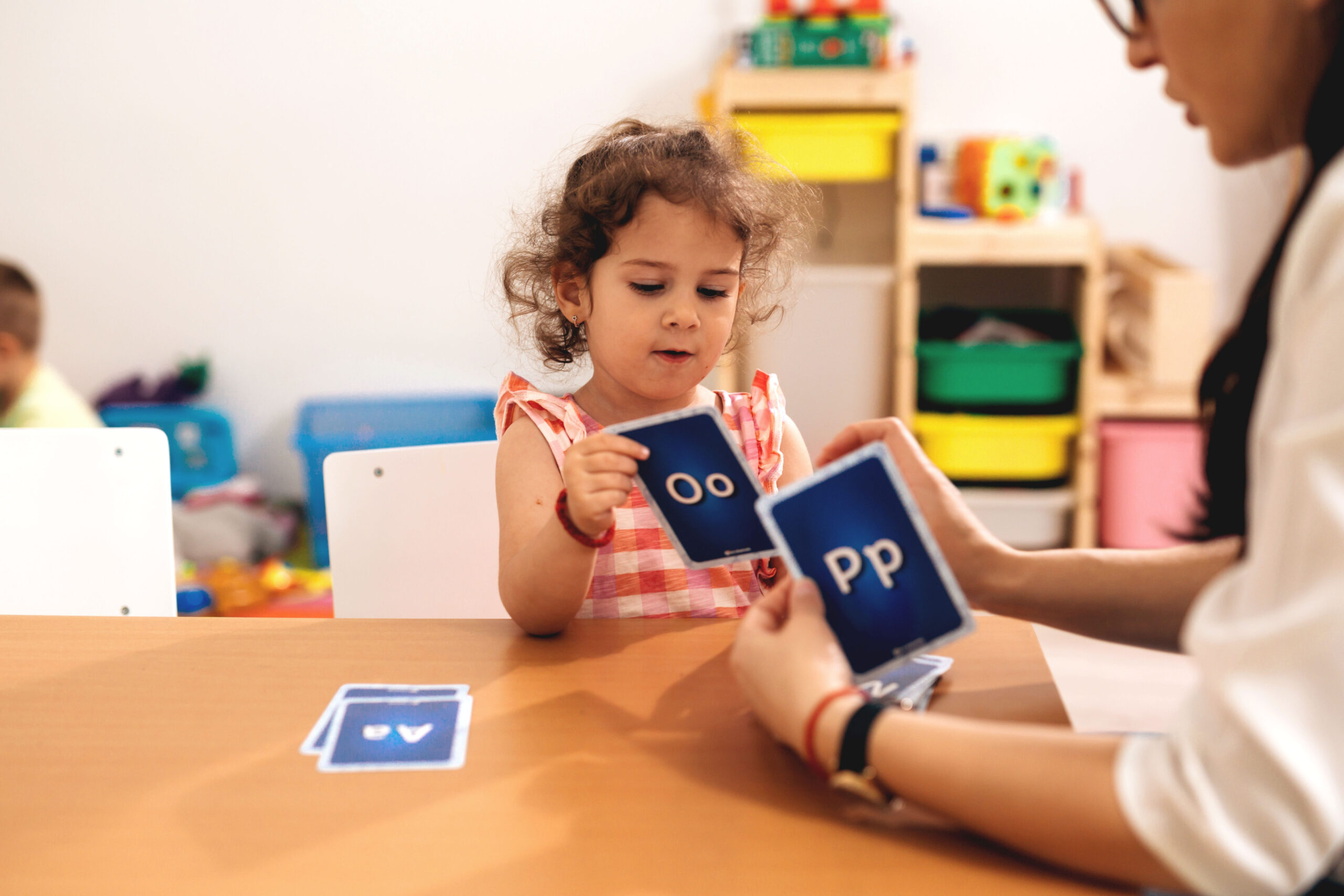 teacher learning child how to correct pronouncing words