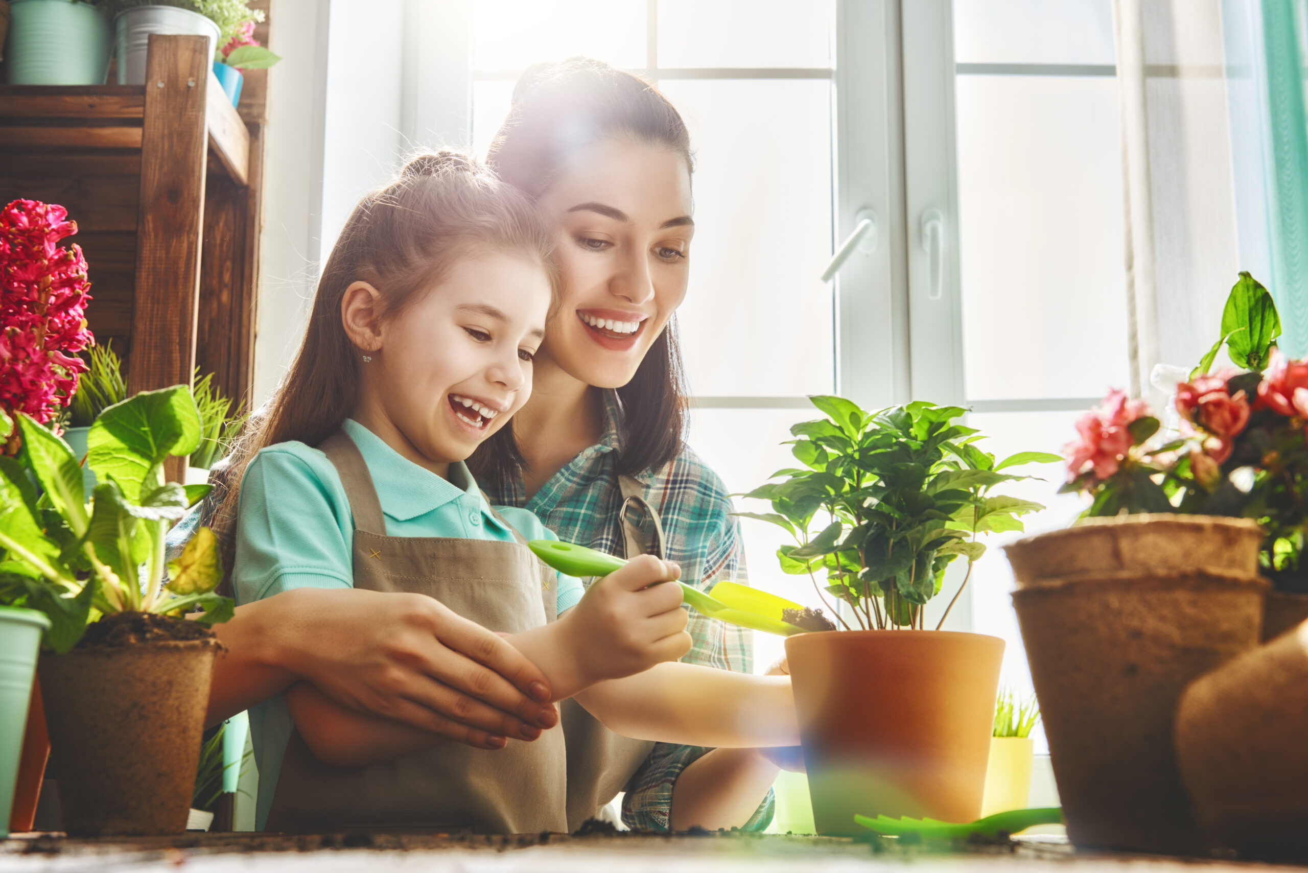 Cute,Child,Girl,Helps,Her,Mother,To,Care,For,Plants.