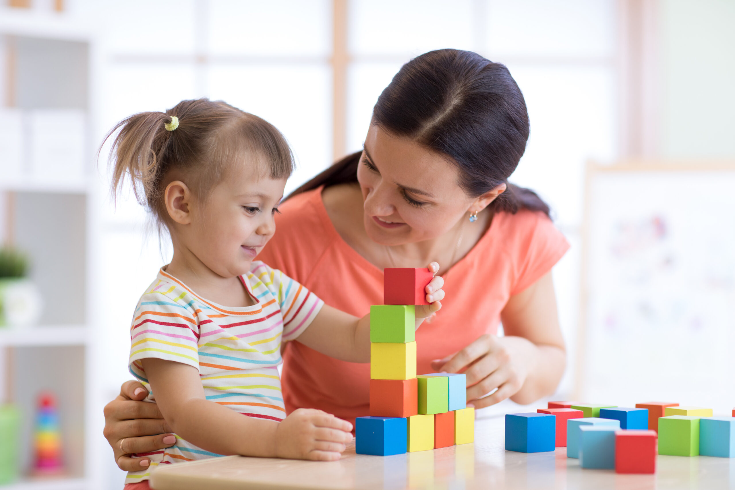 Cute,Woman,And,Kid,Girl,Playing,Educational,Toys,At,Kindergarten